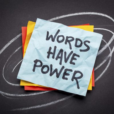 words have power - reminder on a sticky note against black paper